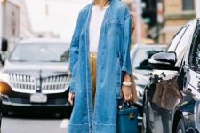With white t-shirt, mustard yellow cropped pants, blue leather basket bag and black and golden ankle strap low heeled shoes
