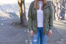 With white turtleneck, olive green belted jacket, distressed cuffed jeans and lilac ankle boots