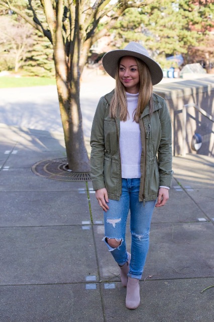 With white turtleneck, olive green belted jacket, distressed cuffed jeans and lilac ankle boots