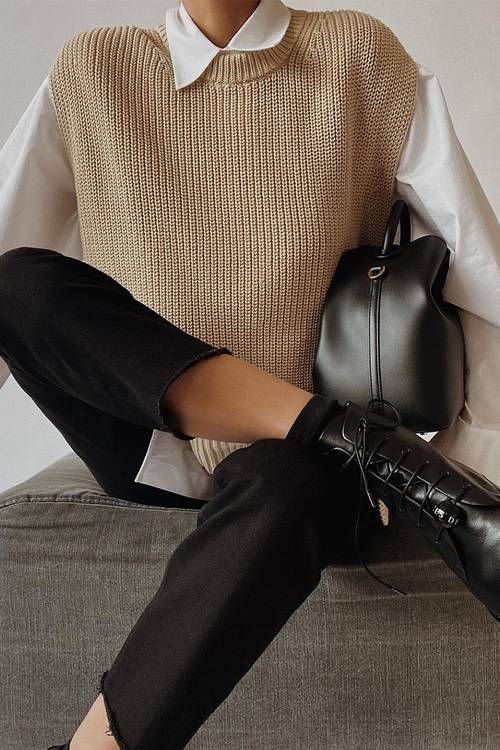 a laconic winter to spring work look with a white shirt, a tan waistcoat, black jeans, black boots and a black bag