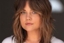 a medium-length wolf cut with caramel balayage and bottleneck bangs plus a bit of messy waves is a lovely idea