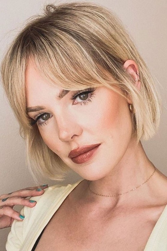 a pretty blonde jaw-line bob with bottleneck bangs is a lovely idea that looks cute and chic