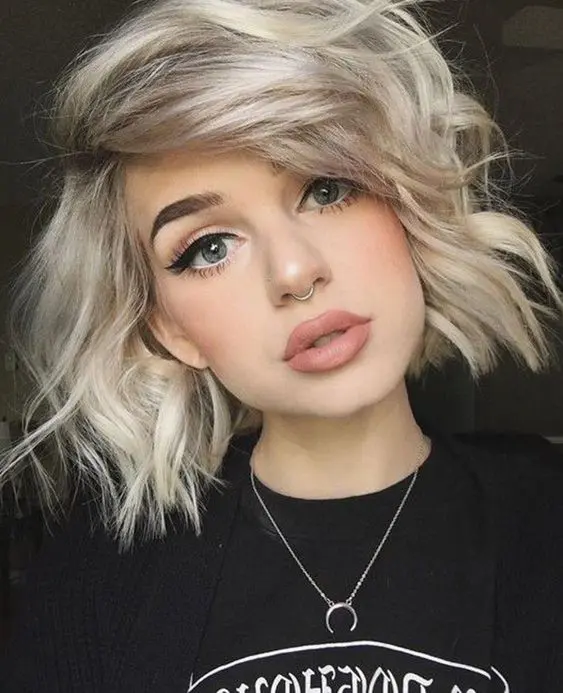 a silver and icy blonde short bob with side bangs and waves is a gorgeous idea with an edgy feel