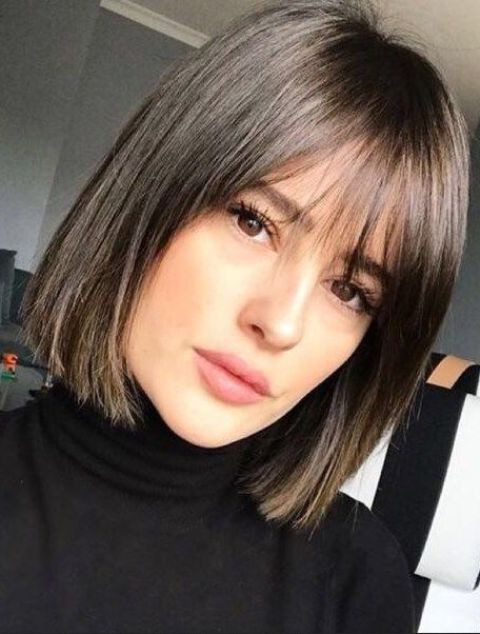 a stylish dark brown short bob with wispy bangs is a timelessly elegant idea that works anytime for any face shape