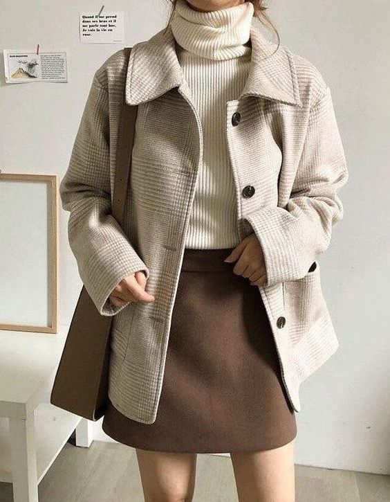a wihte ribbed turtleneck, a brown mini skirt, a neutral printed cropped coat and a taupe bag