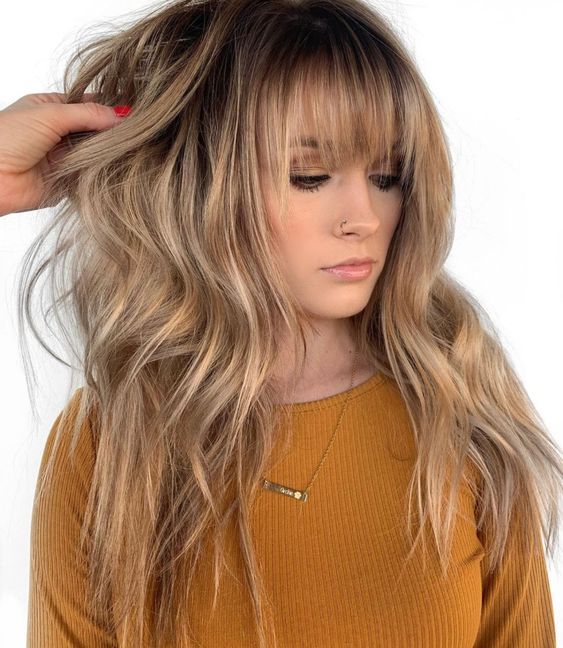 beautiful long honey blonde hair with layered bangs and waves is a very romantic and very girlish idea