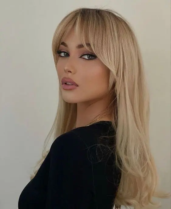 fabulous long blonde hair with much volume and layered curtains bangs for delicate face framing