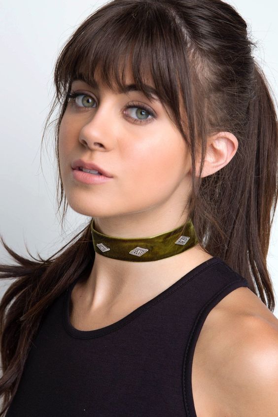 long dark brown hair in a high ponytail and with layered bangs for a cuter and more girlish look