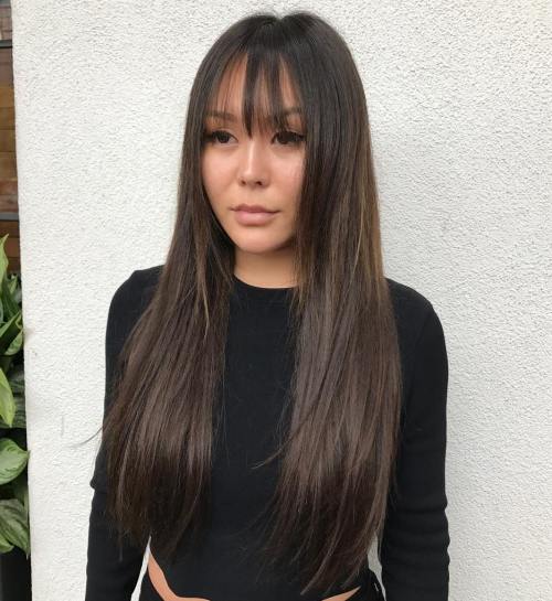 long dark brown hair paired up with long wispy bangs is a very cool style you can try any time
