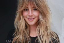 long wavy blonde hair with plenty of texture and volume plus caramel balayage and layered bangs