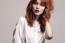 lovely textural copper red hair with waves and bottleneck bangs for a bolder look