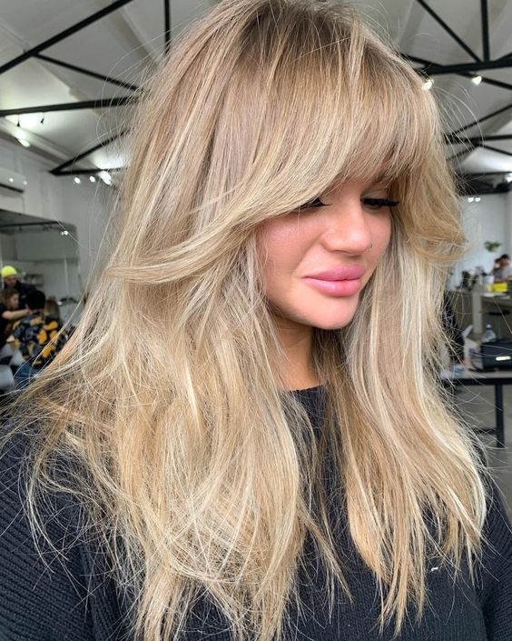 naturally blonde long hair with balayage and much volume, with layered bangs and lowlights is amazing