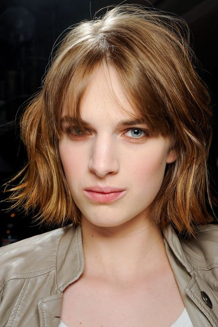 short caramel and light blonde hair with texture and bottleneck bangs for a catchy and chic look