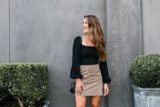 03 a black top with a square neckline and puff sleeves, a tan mini skirt, black shoes and a black bag