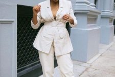 03 a chic and comfy outfit with a tan-colored ribbed turtleneck, a creamy linen belted blazer, creamy pants and white trainers