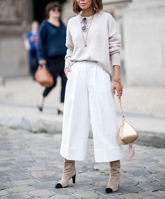 a neutral oversized jumper, white culottes, grey suede boots, a gold eye-catchy bag plus layered necklaces