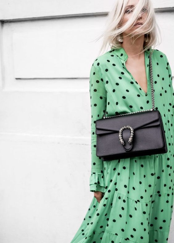 a green and black polka dot midi A-line shirtdress and a black bag for a romantic and feminine look at the brunch