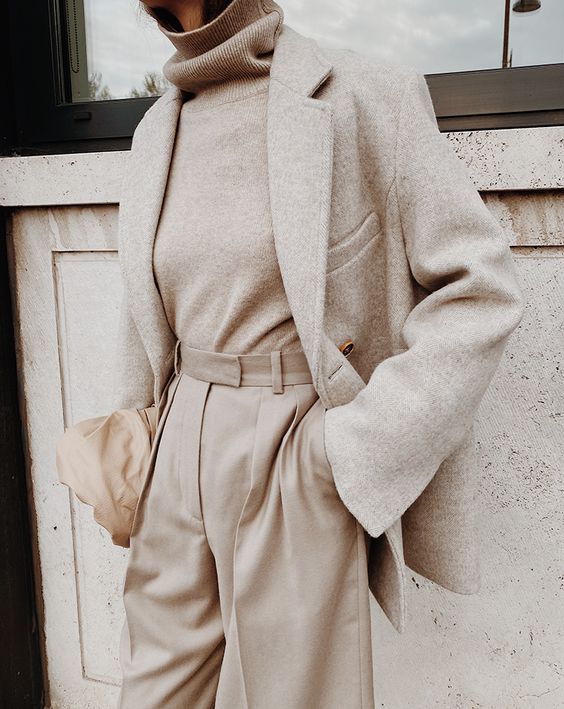 a neutral work look with a tan turtleneck, matching high-waisted pants, a creamy blazer and a tan bag