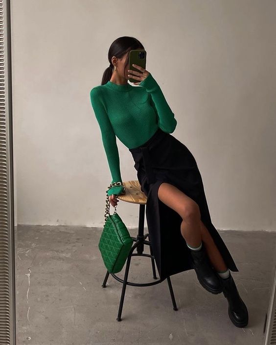 an emerald turtleneck, a matching woven bag, a black high waisted midi skirt, black chunky boots
