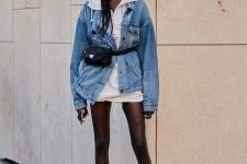 13 a trendy look with a white oversized hoodie, a blue denim jacket, brown booties and a black waistbag
