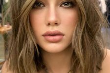 16 a soft and delicate light brunette shoulder-length bob with warm blonde balayage and messy waves is chic