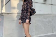 17 a dark floral mini dress with long sleeves, a printed bag and brown cowboy boots for a chic look