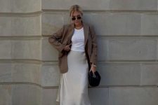 17 a white top, a creamy slip midi skirt, tan heeled mules, a taupe oversized blazer and a black bag for a contrast