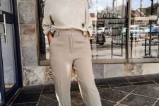18 an easy and comfy outfit with an off-white ribbed jumper tucked into grey trousers, blush shoes and statement sunglasses