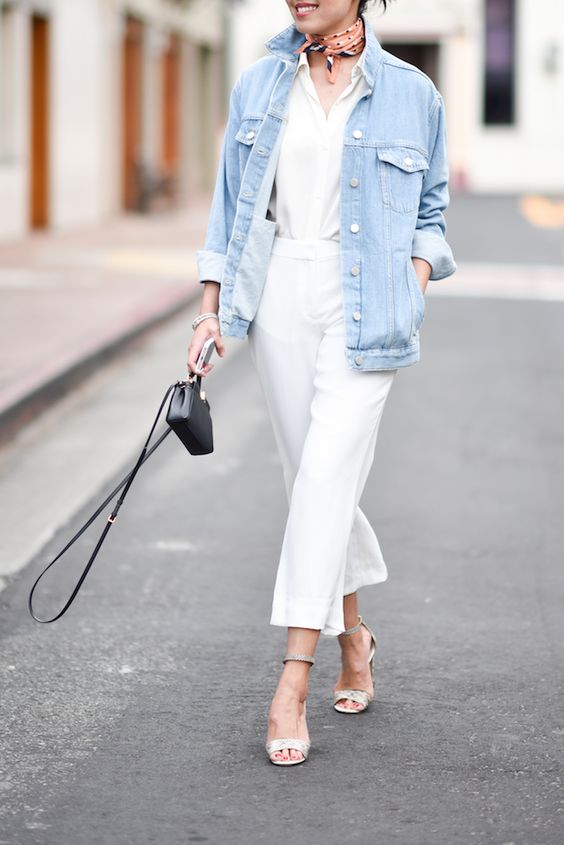 a chic spring brunch look with a white shirt and pants, silver ankle strap heels, a bleached denim jacket and a black bag