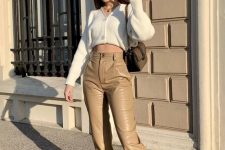 20 a classy outfit with a white cropped cardigan, tan leather high-waisted pants, matching lace up boots and a brown bag