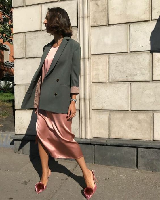 a pink midi dress, a green overiszed blazer, pink shoes with pompoms for a cute look