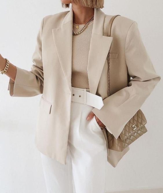 white high-waisted pants, a tan top, a tan oversized blazer, a grey bag for the office