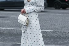 22 a refined outfit with a white and green polka dot midi dress with a deep neckline, a white shirt and grey boots, a green headband