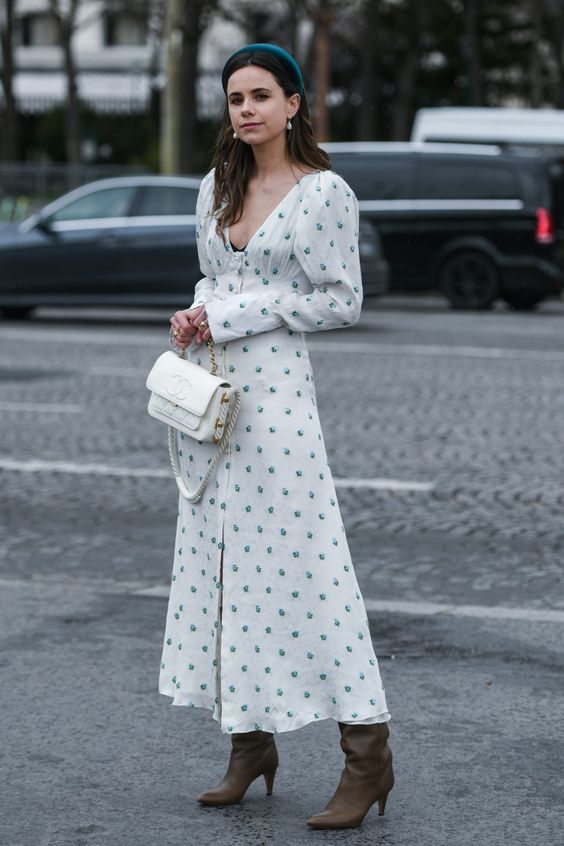 a refined outfit with a white and green polka dot midi dress with a deep neckline, a white shirt and grey boots, a green headband