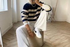 23 a navy and cream striped sweater, white trousers, white and black sneakers and a chain necklace for maximal comfort