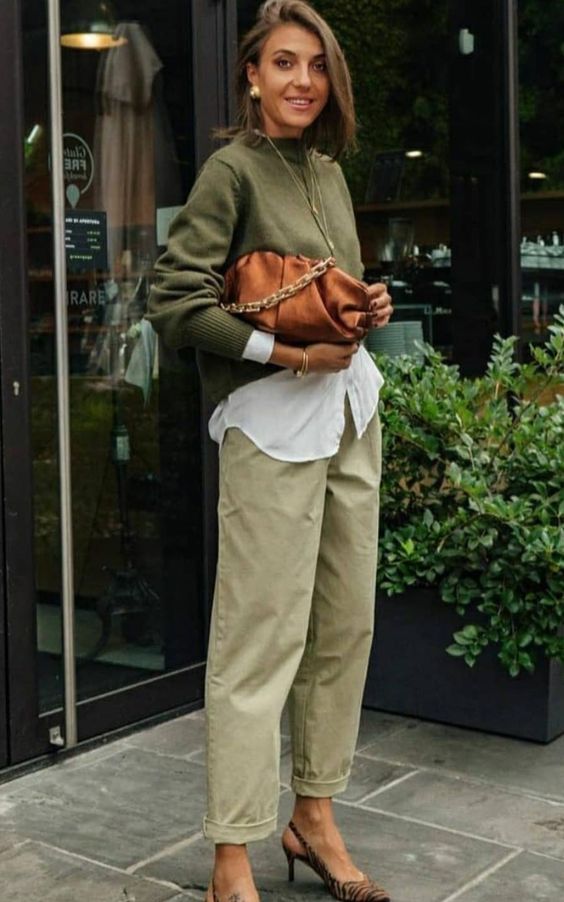 a lovely brunch look with a white shirt, a green jumper, light green pants, zebra print slingbacks and a brown clutch