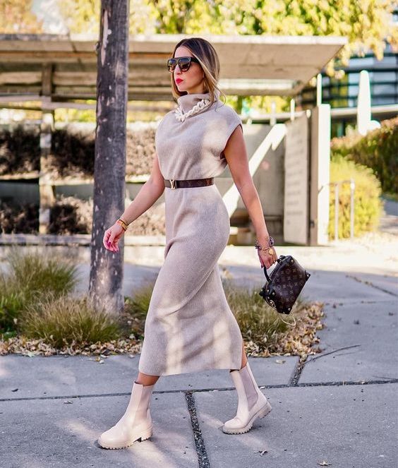 a grey sleeveless midi dress, a chain necklace, a brown belt, neutral Chelsea boots and a brown bag
