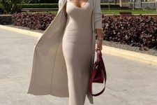 29 a stylish and comfy look with a ribbed neutral maxi dress and a matching long cardigan, white trainers and a burgundy bag