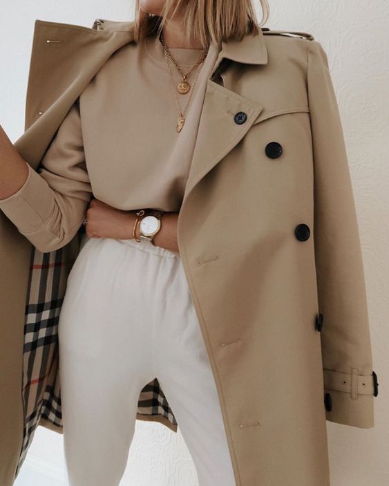 a tan long sleeve top, white sweatpants, a classic tan Burberry trench for a comfy and cozy spring look
