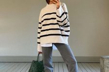 31 a white shirt, an oversized Breton style jumper, grey jeans, white slippers and a beautiful green woven bag