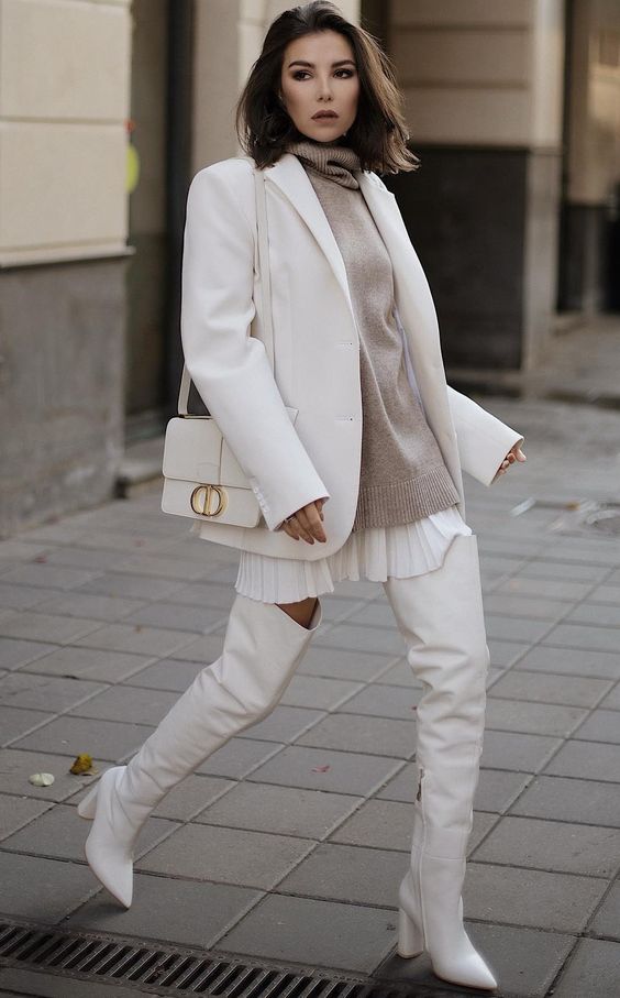 a white mini shirtdress, a grey oversized sweater, high boots, a blazer and a stylish bag