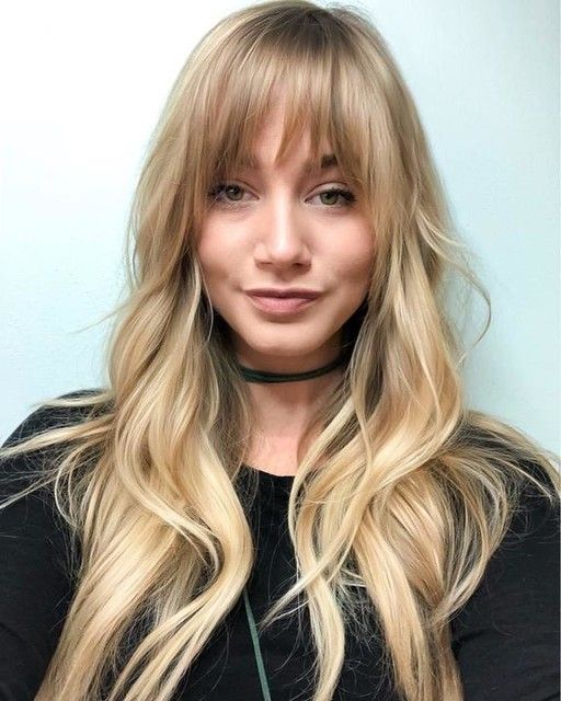 chic and lovely long wavy locks with shaggy bangs show off a beautiful and expensive blonde tone