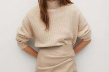 With beige loose turtleneck sweater