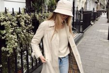 With beige sweater, beige midi trench coat, light blue skinny jeans and white sneakers