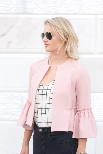 With black and white checked top, sunglasses and dark colored jeans