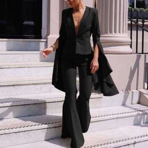With black flare trousers, high heels and golden necklace