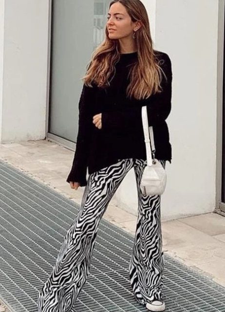 With black loose sweater, white leather bag and sneakers