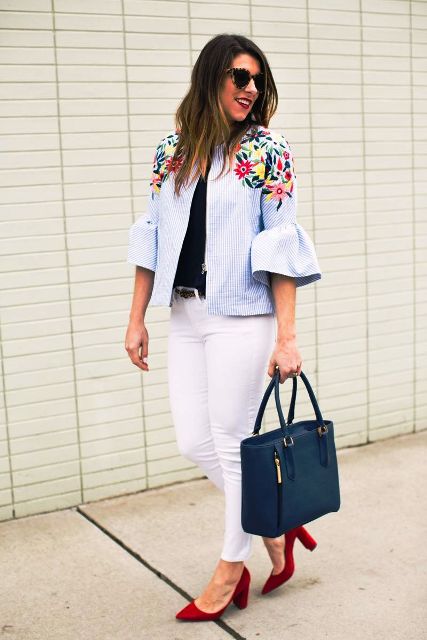With black wrap shirt, white skinny pants, navy blue leather tote bag, sunglasses, belt and red suede shoes
