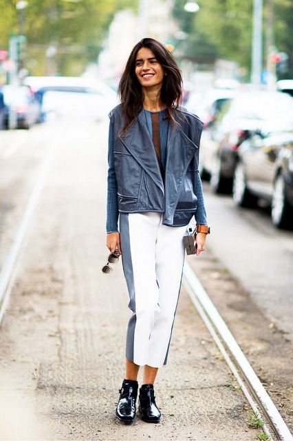 With blue shirt, blue leather jacket, white and blue cropped pants and clutch
