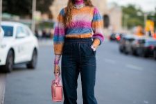 With colorful turtleneck sweater, pale pink leather bag, navy blue jogger pants, silver necklace and pink low heeled mules
